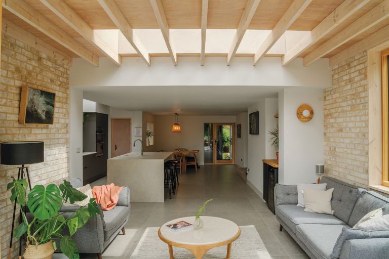 View from the bifold doors looking back into the house. The seating area is in the foreground and the kitchen is at the back