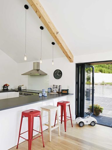 White kitchen units are topped with a quartz cement work surface