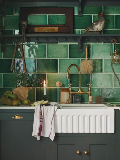 Green kitchen tiles and base units. Kitchen by Devol Kitchens