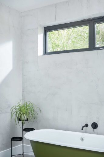 Kohtalo. Bathroom. Free-standing bath with green exterior. White tiles