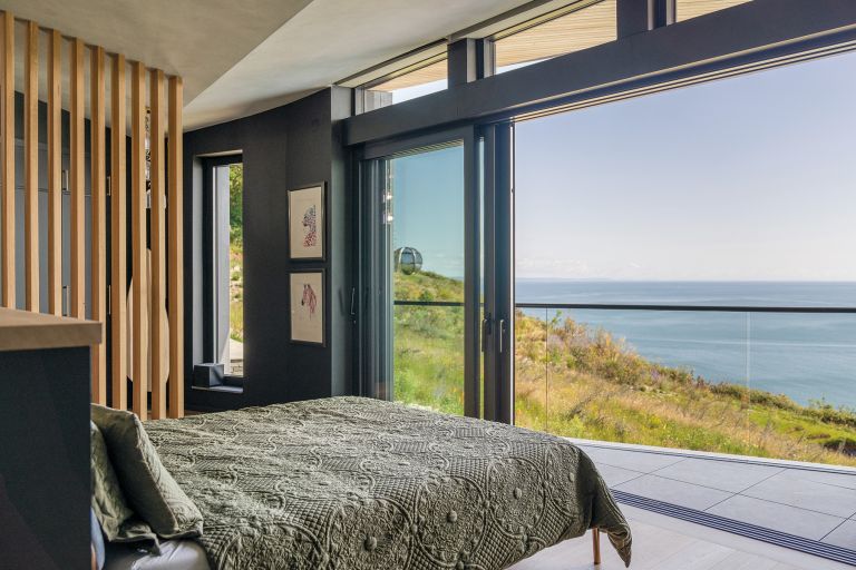 Labrador Bay House, bed. The bed is set infront of a large window that looks over Labrador Bay