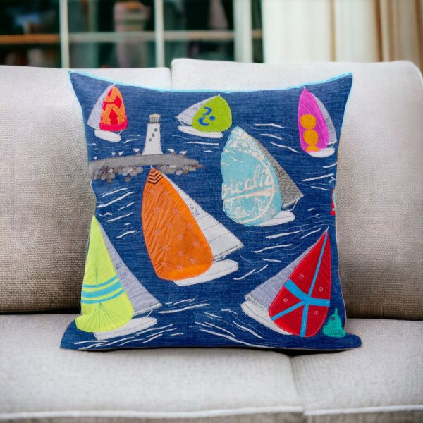 Sailing Boats cushion by Jackie Gales. Colourful boats on deep blue background